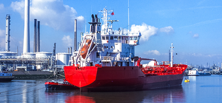 View of the entrance to the Rotterdam harbour, the Netherlands with one red ship